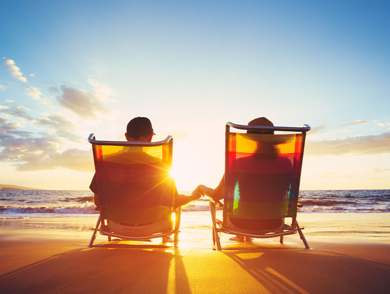 Couple sitting together at sunset